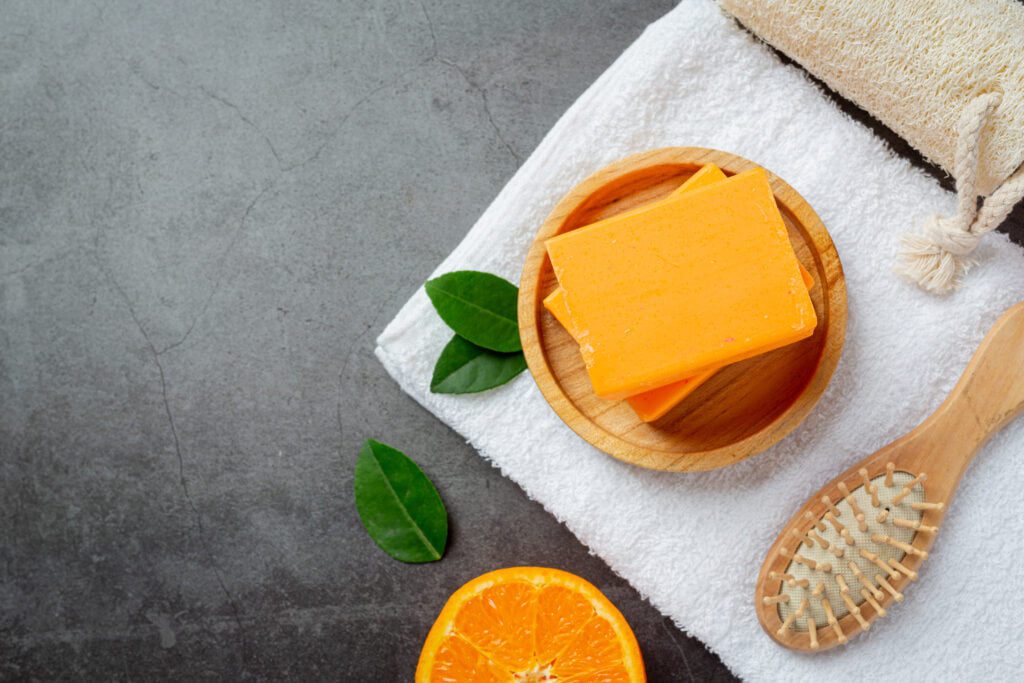 Orange soap with fresh orange on dark background Orange soap with fresh orange on dark background