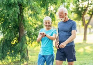 A person walking in a garden or park with a pedometer